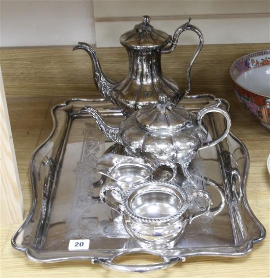 A silver plated two handled tea tray, a plated tea and coffee pot and a plated sugar bowl and cream jug.